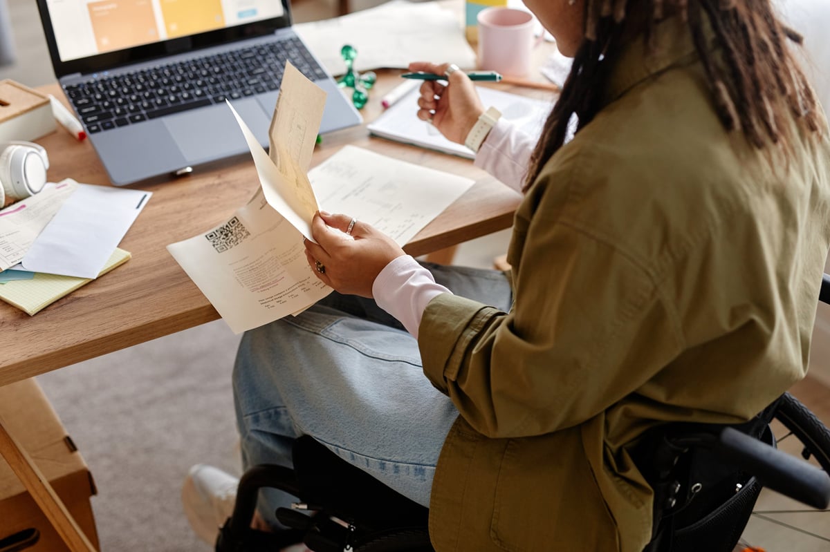 Is NDIS Plan Management Free - Participant reviewing documents with smile